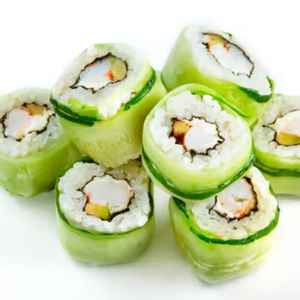 Close-up of several Sushi-Ko Bainbridge sushi rolls, wrapped in thin cucumber slices, on a white background.